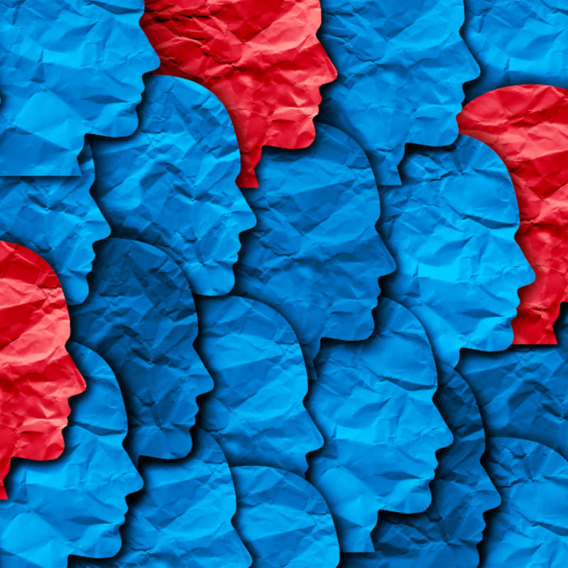 image of blue and red faces in profile representing herd immunity