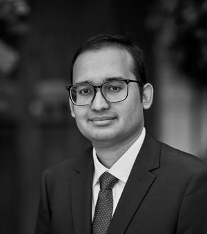 Black and white photo headshot of Faisal Feroz