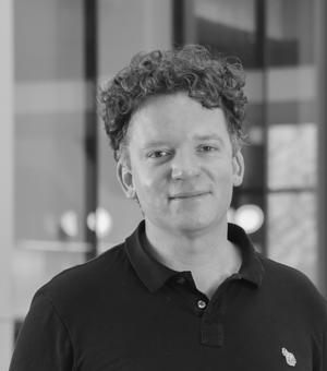 Black and white headshot photograph of Mark Butler